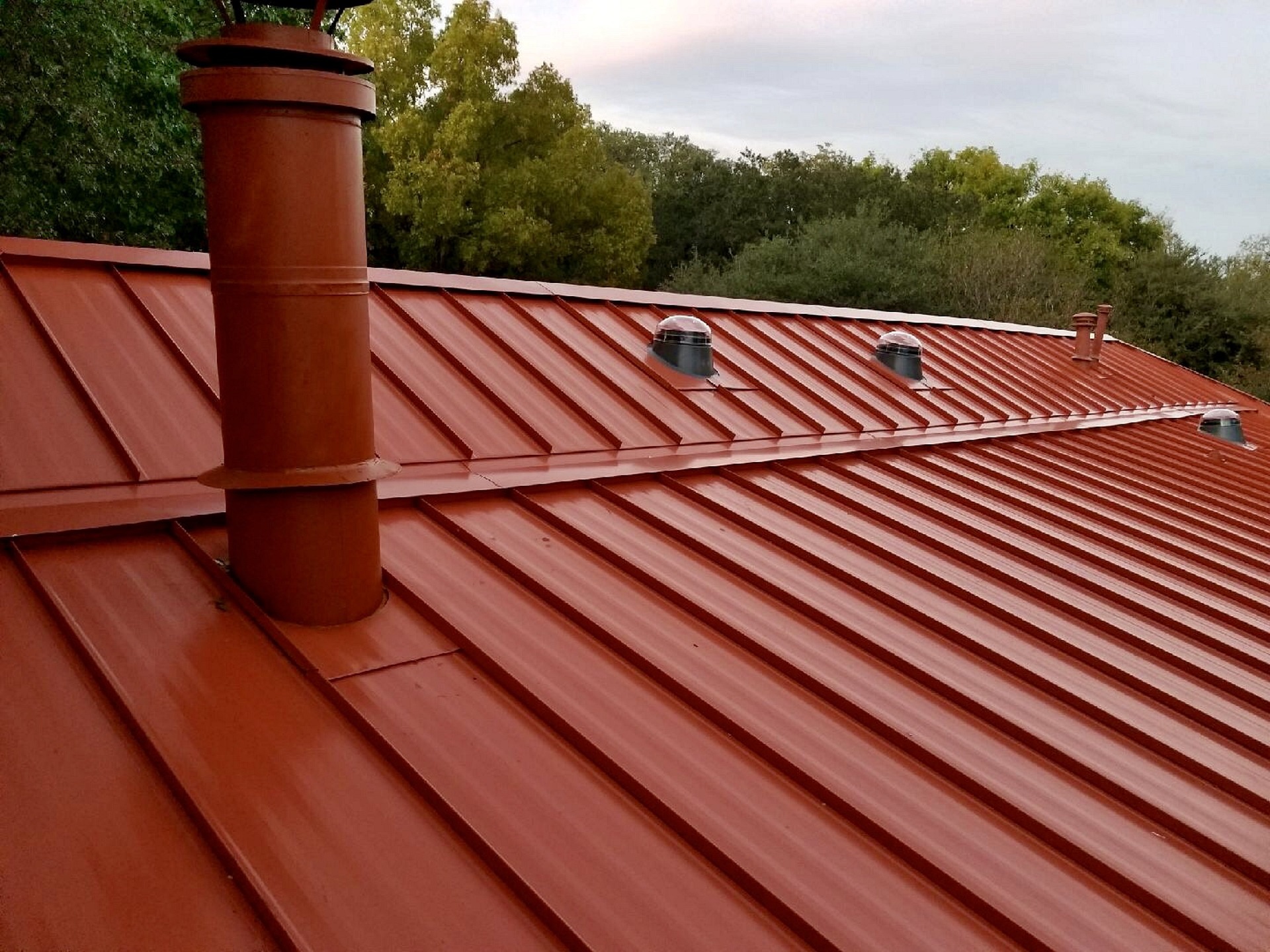 Beautiful red metal panels installed by Norm's Roofing