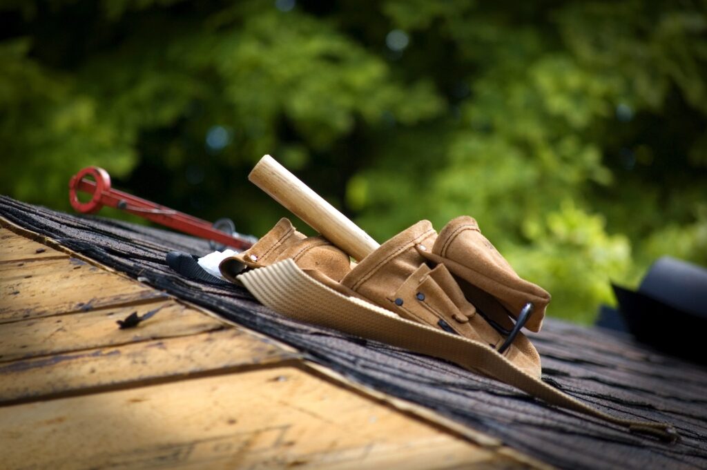 Resolve leaks promptly with expert leak repairs from Norm's Roofing. Toolbelt photo.