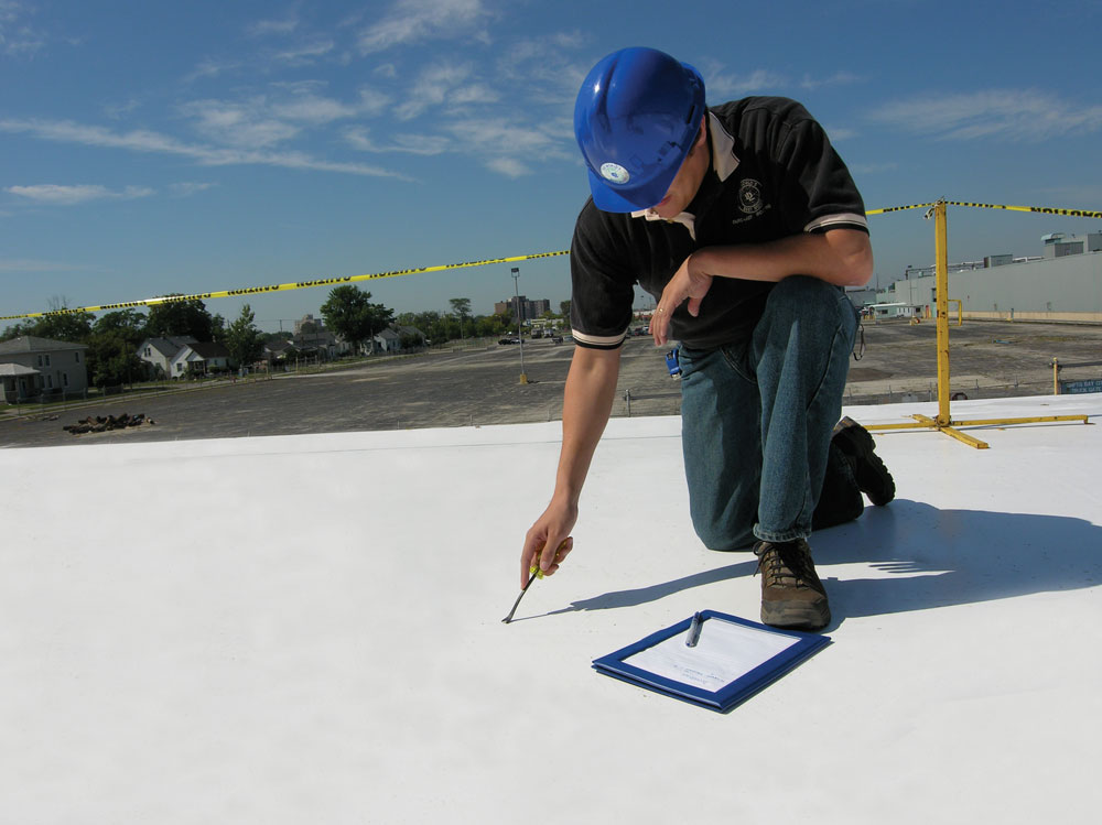 Norm's Roofing employee in Michigan completing a roof inspection