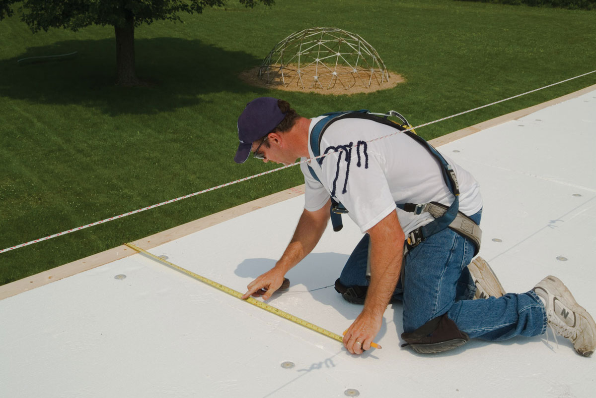 Expert roofer from Norm's Roofing completing a roof inspection