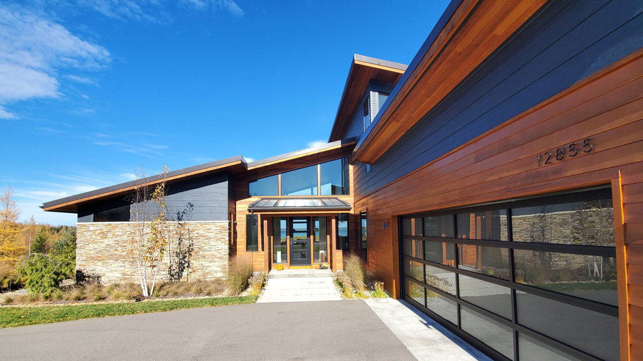 Gorgeous modern home with siding and metal roofing installed by experts Norm's Roofing