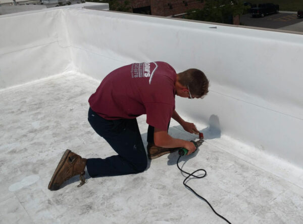 Roofing expert sealing Duro-Last commercial roofing seams.